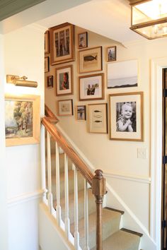 a staircase with many framed pictures on the wall