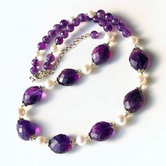 "THIS LISTING IS FOR THE NECKLACE ONLY Earrings shown for illustration and listed separately MATERIALS & DIMENSIONS ✦ Natural AMETHYST, deep purple, faceted ovals approx. 16x14mm, round beads 6mm; ✦ Freshwater PEARLS, white, round approx. 7|5mm; ✦ STERLING SILVER bead caps, crimps, jump rings and lobster claw clasp with 2\" inches extender chain; ✦ Total circumference length is about 16\" inches (41cm), plus 2\" inches extension; ✦ You will receive shown necklace; PACKAGING & SHIPPING ✦ Your nec Purple Amethyst Jeweled Necklaces, Elegant Faceted Purple Crystal Necklace, Elegant Purple Faceted Crystal Necklace, Purple Jeweled Necklace, Formal Amethyst Gemstone Bead Necklace, Elegant Purple Beaded Necklace With Gemstones, Elegant Round Amethyst Crystal Necklaces, Purple Faceted Jewelry For Anniversary, Elegant Handmade Purple Crystal Necklaces