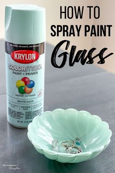 a bottle of krylon spray paint next to a bowl with rings on it