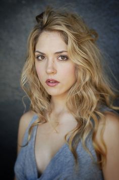 a woman with long blonde hair posing for a photo