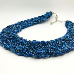 "Features: * Beautiful necklace * Seed beads * Blue and navy color * Item# U23092 Size: 16\" length Condition: Pre-Owned Good Gently Loved...  Thank you for visiting our shop!" Blue Beaded Chain Choker, Blue Beaded Choker With Faceted Beads, Blue Faceted Beads Choker Necklace, Blue Beaded Chain Bib Necklace With Round Beads, Blue Beaded Chain Bib Necklaces, Blue Beaded Choker With Round Beads, Blue Bib Necklace With Beaded Chain And Round Beads, Blue Round Beaded Chain Bib Necklace, Blue Choker With Tiny Beads