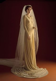 a woman in a wedding dress with a veil on her head