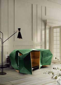 an unusual green table in the middle of a room with white walls and flooring