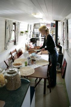 a woman standing at the end of a kitchen table