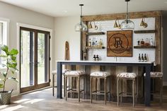 a bar with four stools in front of it