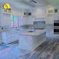 a large kitchen with white cabinets and wood floors