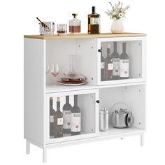 a white shelf with bottles and glasses on it