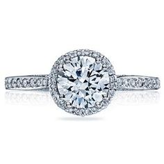 an oval cut diamond ring with pave set shoulders