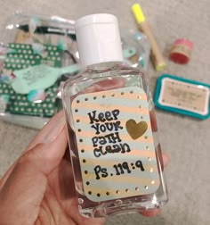 a hand holding a small bottle with a message on it that says keep your teeth clean