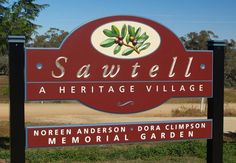 the sign for sawtell heritage village in north anderson, dora cumpson memorial garden