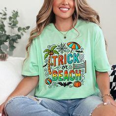 Our funny trick or treat Halloween shirt features the text "Trick or Beach" and is a perfect Halloween gift for your favorite beach bum or beach lover! This unisex soft style t-shirt that comes in 6 beautiful colors.  OTHER STYLES Message me if you would like to see this design on other styles OR if you would like it customized!  T-SHIRT INFORMATION Gildan 64000 Unisex SoftStyle T-shirt Fit: Runs true to size Fabric:  100% cotton (Heather colors and sports grey include polyester) Weight: Lightweight (4.5 oz) Size Range: Men's Sizes S-5X - Please see size chart in photos area Playful Letter Print T-shirt For Vacation, Playful Crew Neck T-shirt For Beach, Playful Letter Print Top For Vacation, Funny Short Sleeve T-shirt For Beach, Funny Beach T-shirt With Print, Letter Print T-shirt For Beach Season Holiday, Playful Letter Print Beach Top, Graphic Print T-shirt For Beach Holiday, Playful Letter Print Top For Beach