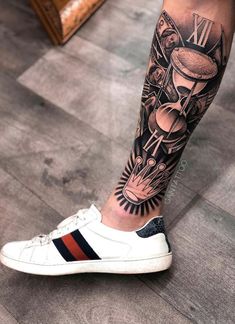 a man's leg with a tattoo on it and an image of a clock