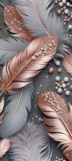 some feathers and pearls on a gray surface