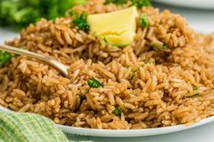 a white plate topped with brown rice and broccoli