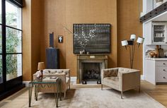 a living room filled with furniture and a flat screen tv mounted on the wall above a fireplace