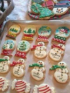 decorated cookies in the shape of snowmen and christmas trees