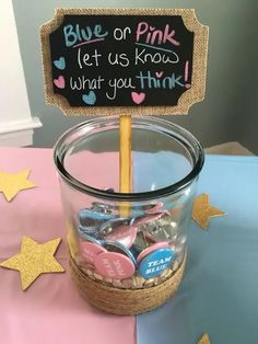 a glass jar filled with candy sitting on top of a blue and pink table cloth