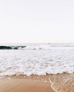 the waves are coming in to the beach and it looks like they're about to hit the shore