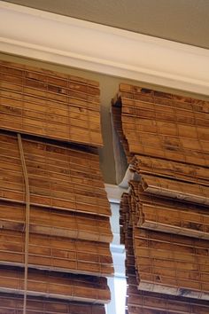 several stacks of bamboo sitting on top of a window sill