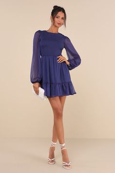 Not even a slice of pie can compete with the Lulus Simply the Sweetest Dark Blue Long Sleeve Smocked Mini Dress! This lovely mini dress has a gauzy chiffon construction that creates long sheer sleeve with elastic cuffs and gathered shoulders, plus a fully smocked bodice with a rounded neckline. High waist sits above a lightly flared mini skirt with a cute ruffle at the hem. Hidden back zipper/clasp. Fit: This garment fits true to size. Length: Mid-thigh. Size medium measures 35" from shoulder to Smocked Ruffle Dress For Party, Mini Length, Party Smocked Ruffle Dress Mini Length, Ruffled Smocked Mini Dress For Party, Party Smocked Mini Dress With Ruffles, Mini Length Smocked Dress With Ruffles For Party, Mini Dress With Smocked Cuffs For Brunch, Brunch Mini Dress With Smocked Cuffs, Blue Tiered Mini Dress With Smocked Back, Chiffon Mini Dress With Smocked Back