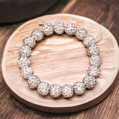 "This wonderful, bright, shiny white bracelet is just gorgeous! If you like bling, this bracelet has it. It is made from clay and rhinestone shamballa beads. It is elastic for the perfect fit and easy to put on. It is 7\" long with 19 beads. This is a bracelet you will love wearing and your friends will ask where you got it!" White Crystal Bracelet With Rhinestones As Gift, White Crystal Bracelet With Bling, Adjustable White Crystal Bracelet With Bling, White Crystal Bracelet With Bling, Adjustable, Shamballa Bracelets, Ladies Bracelet, White Bracelet, White Bracelets, A Bracelet