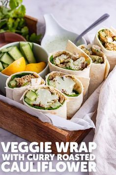 vegetable wrap with curry roasted cauliflower and cucumber in a wooden tray