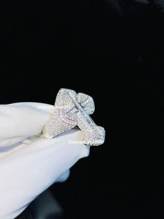 a person wearing a diamond ring on their finger