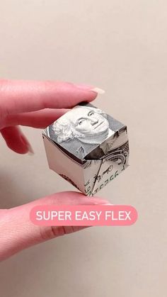 a hand holding a money origami piece with the words super easy flex on it