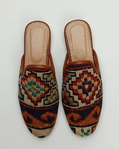 Welcome to AliDesignStore This Kilim Mules one -of-A-kind! Upper Made of a Hand-Selected Sumak Kilim Rug . Sumak Kilims Are Hand Crafted From a Mixture of Silk and Wool.and Have Stronger weave. - Handcrafted - Materials : Handwoven Sumak Kilim                        Leather Sole                        Leather Trimmed                       Leather Lining                       Stacked Leather Sole                       Rubber Under The Stacked Heel  Care:   Soft Clothing Brush İs Recommended To Cl Bohemian Handmade Slip-on Mules, Handmade Bohemian Closed Toe Mules, Handmade Bohemian Slip-on Mules, Bohemian Leather Closed Toe Mules, Bohemian Closed Toe Leather Mules, Traditional Handmade Mules, Traditional Closed Toe Mules With Woven Sole, Traditional Handmade Flat Mules, Traditional Mules With Rubber Sole And Round Toe