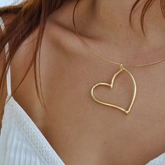 Details: ﻿ BRASS HAND DIPPED IN A 14K GOLD PLATE INQUIRE FOR CHAIN OPTIONS OR 14K GOLD Gold Heart Charm Choker Jewelry, Gold Heart Charm Choker Necklace, Gold Heart Charm Choker, Gold Choker Necklace With Heart Charm, Gold Necklace With Large Heart Pendant, Elegant Gold Choker With Heart Charm, Valentine's Day Heart Pendant Jewelry, Gold Heart Pendant Large Jewelry, Gold Heart Shaped Clavicle Chain Choker