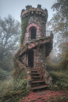 an old stone tower with ivy growing on it's side and stairs leading up to the top