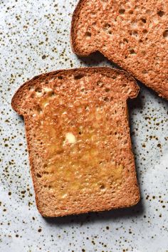 two pieces of bread on a plate with sprinkles