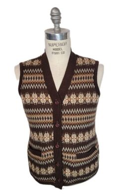 This wonderful sweater vest has a bold, multilayer design with 2 pockets and buttons up the front.  Tag reads: Othello From Italy with Love Size XL Shoulders-   Chest- 42 inches Length- 24 inches Condition is good with little to no signs of wear. All items are vintage and will be described as accurately as possible.  These are not NEW items and will therefore may have some imperfections. Again, I will try to describe items to the best of my knowledge.  All Sales Are Final! Buyer pays all related Casual Fair Isle Pattern Vest For Winter, Casual Fair Isle Vest For Winter, Vintage Winter Sweater Vest, Casual Fair Isle Vest For Fall, Classic Winter Sweater Vest With Pockets, Retro Brown Sweater Vest For Winter, Sleeveless Sweater Vest With Fair Isle Pattern For Winter, Sleeveless Fair Isle Sweater Vest For Winter, Brown Sweater Vest With Pockets For Fall