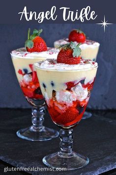 three desserts with strawberries and whipped cream in glasses on a black tablecloth