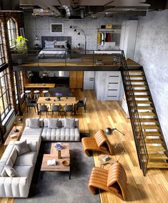 an aerial view of a living room with couches, tables and stairs leading up to the loft