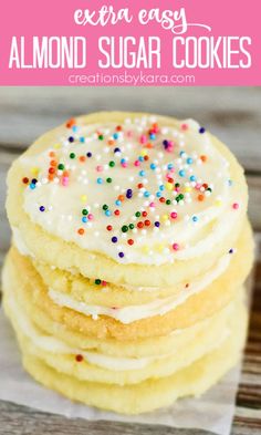 a stack of sugar cookies with white frosting and sprinkles on top