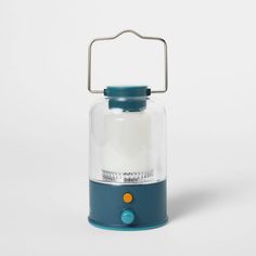 a blue and white lantern with a glass cover on the top, sitting against a white background