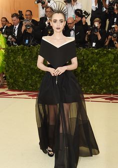 a woman in a black dress with sheer skirt