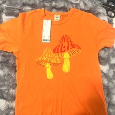 Perfect Condition Never Worn, With Tag. Urban Outfitters Letter Print T-shirt For Spring, Urban Outfitters Cotton Tops With Text Print, Urban Outfitters Graphic Print Cotton Tops, Relaxed Fit Screen Print Top By Urban Outfitters, Basic Orange T-shirt For Spring, Urban Outfitters Relaxed Fit Screen Print Top, Urban Outfitters Cotton Tops With Letter Print, Urban Outfitters Screen Print Summer Tops, Urban Outfitters Summer Top With Text Print