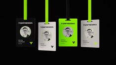 three id cards with neon green string attached to them