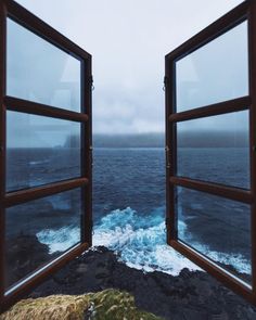 an open window looking out at the ocean