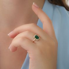 "14k Gold Emerald and Diamond Ring / Solid Gold Diamond Ring / Emerald Engagement Ring / Halo Rectangular Setting / Dainty Emerald Ring ✔ Handmade ✔ Setting Size: 9.5 x 7.5 mm ✔ Diamond Ct Weight: 0.09ctw ✔ Emerald Ct Weight: 1.15 All our emeralds are treated natural emeralds (Emeralds are typically treated with oil or other \"fillers\" to draw the filling substance into any surface-reaching fissures to improve the clarity of the emerald) ✔ Band Thickness: 1.2mm ✔ Solid Gold ✔ Natural Diamonds a Ring Designs With Green Stone, Emareld Ring Design, Emerald Rings Design, Gold Rings With Green Stone, Green Emerald Ring Gold, Gold Ring Emerald Stone, Green Diamond Ring Engagement, Emerald Gold Rings, Fine Jewelry Green Open Ring