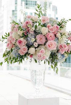 a vase filled with pink and white flowers