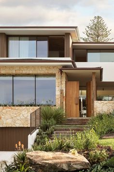 a modern house with stone and wood accents