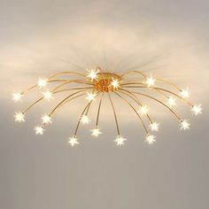 a chandelier with stars hanging from the ceiling