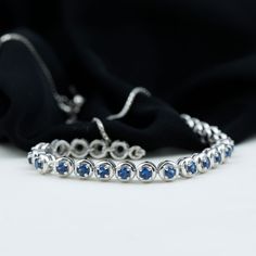 Product Details This Tennis Chain Bracelet is perfectly decorated with round shape Created Blue Sapphire in a semi eternity style in a Prong Setting. This Rope Chain Bracelet will magnify the beauty of your wrist and make your wrist glossy. Product Information SKU SHP-BRACELET0621104297 Length 177.8 mm Width 3.8 mm Height 3.2 mm Weight 6.56 gm (Approximate) LAB CREATED BLUE SAPPHIRE INFORMATION No.of Stones 23 Pieces Total Weight 3.45 Carat (Approximate) Dimension(approx) Round-3X3 mm-23 Pcs Col Rope Chain, Chain Bracelet, Prong Setting, Arm Band, Blue Sapphire, Tennis, Sapphire, Blue Color, Bracelet