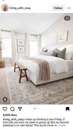 a bedroom with white walls and carpeted flooring has a large bed in it