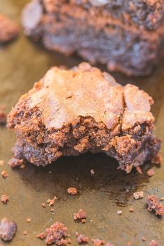 two pieces of brownie sitting on top of a table