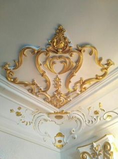 the ceiling is decorated in gold and white