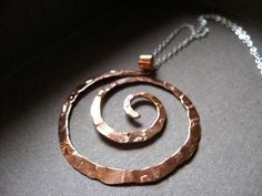 "SIZE: 1 5/8\"x W 1 3/8\" (16\", 18\" or 20\" chain) Symbolism of the spiral Balance Progress Direction Initiation Centering Expansion Awareness Connection Journeying Development This bold spiral pendant is inspired by the graceful spirals of the nautilus. Each spiral is hand shaped, hammered with my signature textured from my antique anvil. The texture comes from years of history, transferring every nick, dent and cranny which is transferred to the metal with every hammer stroke Great for every Adjustable Spiral Nickel-free Necklace, Adjustable Spiral Necklace Nickel Free, Symbolic Adjustable Spiral Jewelry, Adjustable Symbolic Spiral Jewelry, Unique Swirl Jewelry As A Gift, Hand Forged Spiral Jewelry Gift, Artisan Spiral Nickel Free Jewelry, Artisan Spiral Metal Jewelry, Adjustable Spiral Bronze Jewelry